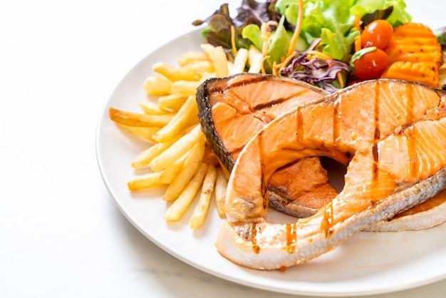 grilled salmon steak fillet with vegetable and french fries