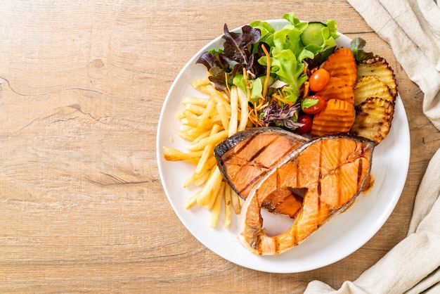 grilled salmon steak fillet with vegetable and french fries