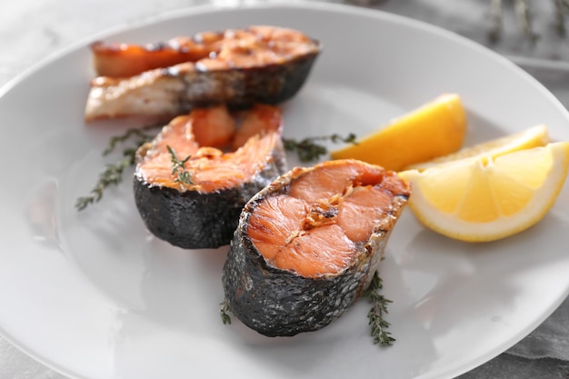 Grilled salmon steaks on plate close up