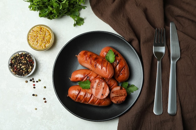 grilled sausage on white textured surface