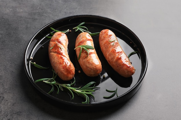 Grilled sausages on black plate