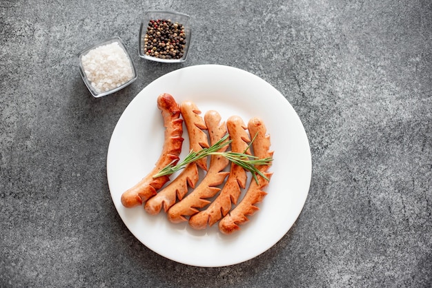 grilled sausages on stone background