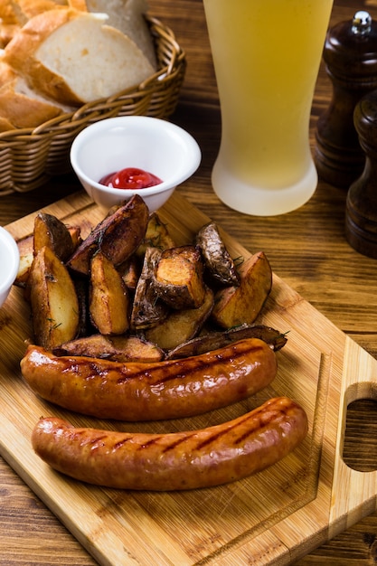 Grilled sausages with roast potato with spices