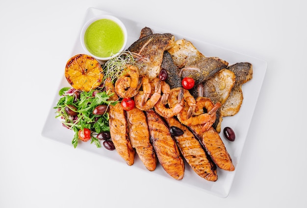 Grilled seafood and fish platter with fresh salad