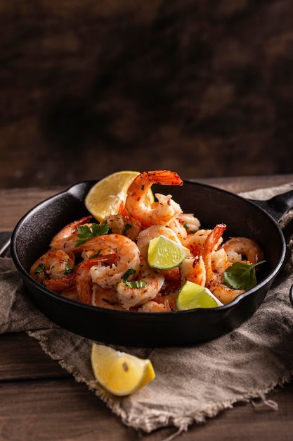 Grilled shrimps with greens and garlic in a pan