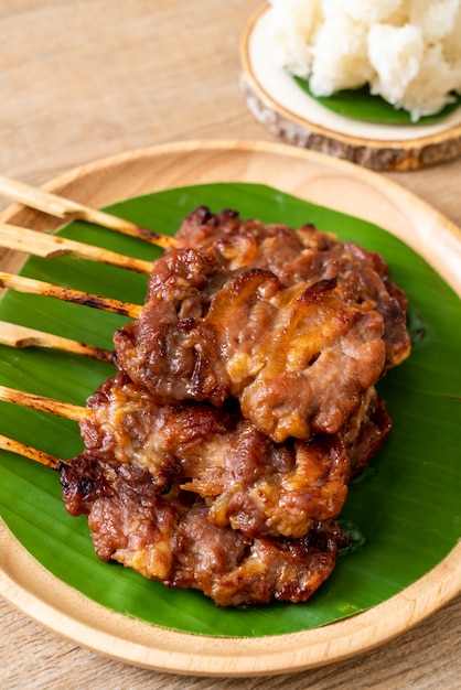 grilled skewered milk pork with white sticky rice