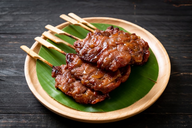 grilled skewered milk pork with white sticky rice