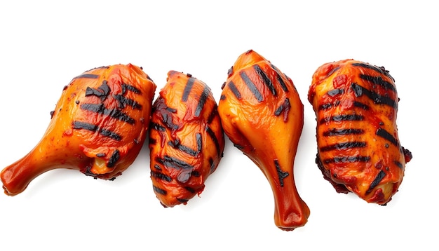 Photo grilled spicy jerk chicken drumsticks and thighs isolated with white highlights