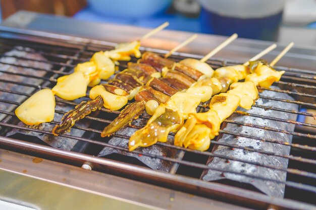 Grilled squid skewers that is roasting on the stove