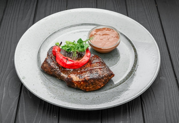 Grilled steak meat with salad from baked pepper