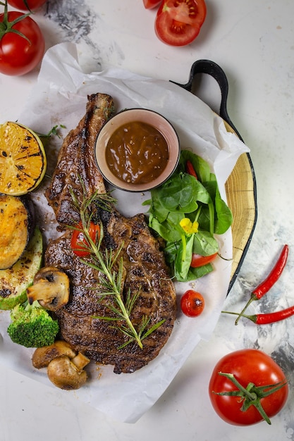 Grilled steak with vegetables and mushroom on white background