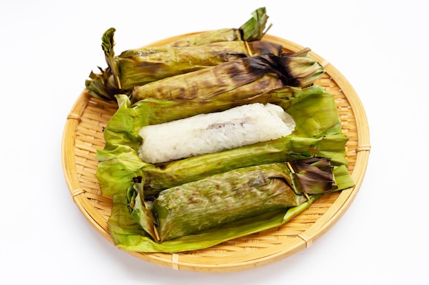 Grilled sticky rice in banana leaves with banana filling