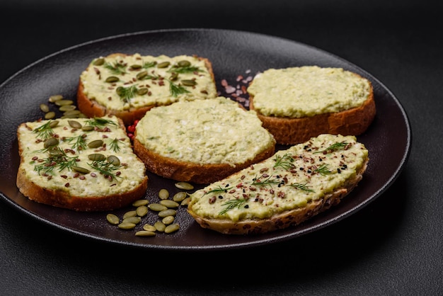 Grilled toast with avocado paste eggs cream cheese salt spices and herbs