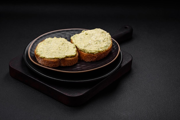 Grilled toast with avocado paste eggs cream cheese salt spices and herbs