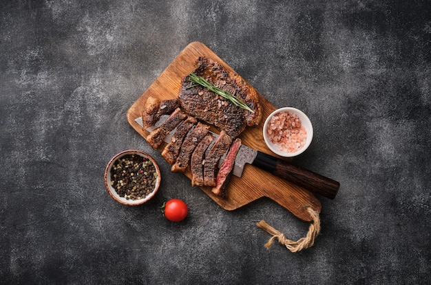 Grilled top sirloin or cup rump beef meat steak on wooden board Dark background Picanha steak