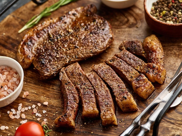 Grilled top sirloin or cup rump beef meat steak on wooden board Dark background Picanha steak