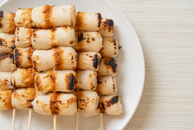 grilled tube shaped fish paste cake or tube squid skewer on plate