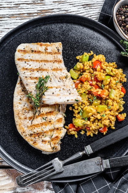 Grilled Turkey breast Steaks with quinoa salad. Top view