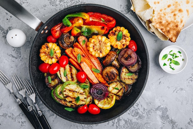 Grilled Vegetable Platter with Zucchini mushrooms eggplant carrots pepper bell tomato onions corn and Yogurt Mint Sauce Top view