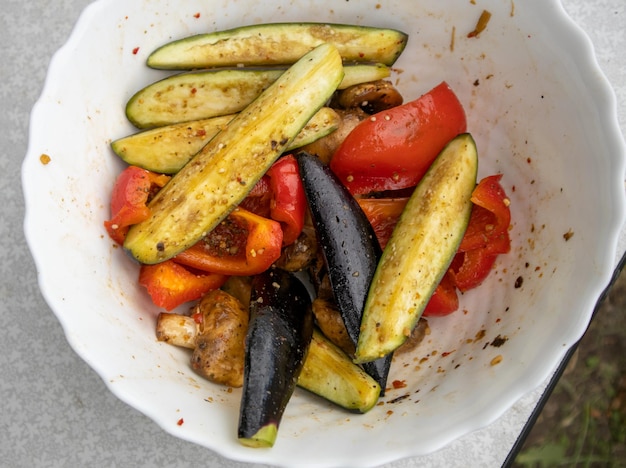 Grilled vegetables bell peppers zucchini eggplant on a white plate top view closeup