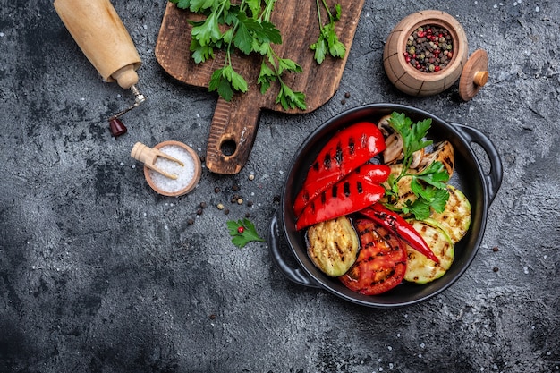 Grilled vegetables in a cast iron grilling pan, Vegan cuisine, banner, menu, recipe place for text, top view,