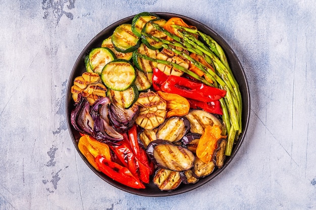 Grilled vegetables on a plate with sauce