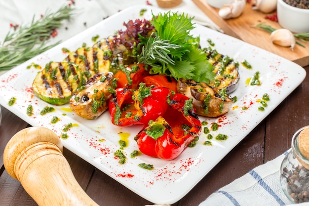 Grilled vegetables on white plates