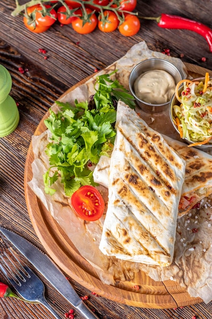 Grilled veggie shawarma served with coleslaw on a wooden board restaurant dish Closeup