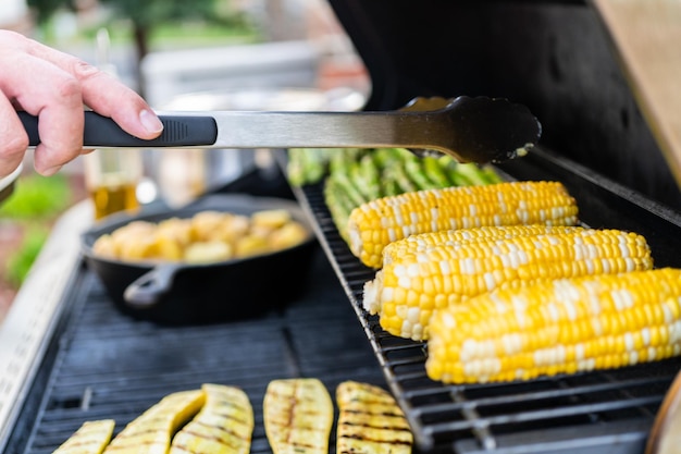 Grilling organic fresh vegetables on an outdoor gas grill in the Summer.