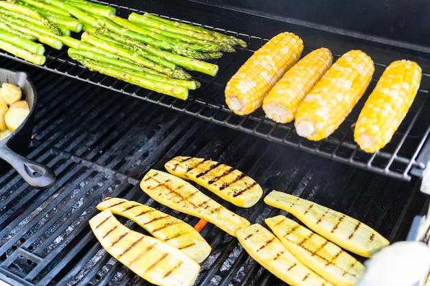 Grilling organic fresh vegetables on an outdoor gas grill in the Summer.