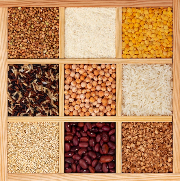 Photo groats in square wooden box collection of cereals beans and seeds top view