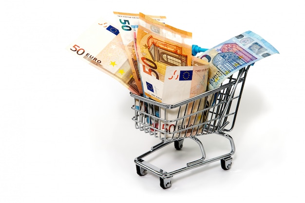 Grocery cart with euro bills isolated on white. shopping, loan, money saving, pension, investments concept