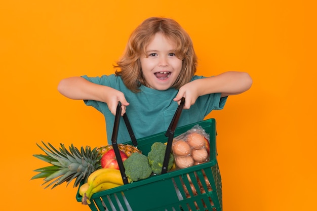 Grocery shop funny child shopping with shopping basket sales and shopping kid boy with shopping bask