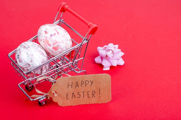 Grocery supermarket cart filled with chicken eggs. Concept of preparing for Easter, buying food. Space for text. Studio Photo