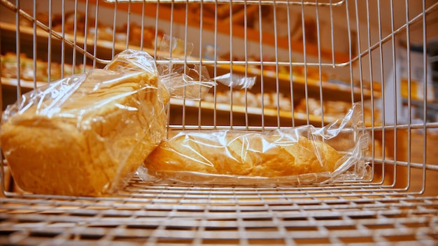 A grocery trolley in the supermarket  buying different bread