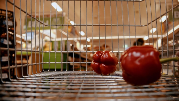 Grocery trolley in the supermarket  buying red bell pepper