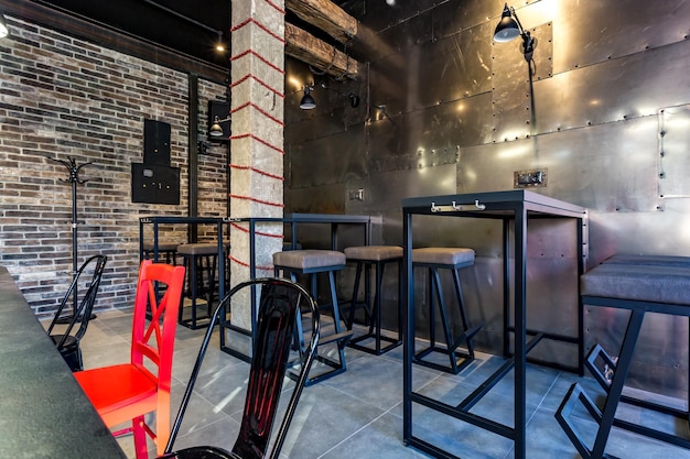 GRODNO BELARUS MARCH 2019 inside interior in modern pub sport bar with dark loft design style with red chairs