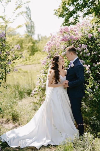 The groom and the bride are walking in the forest