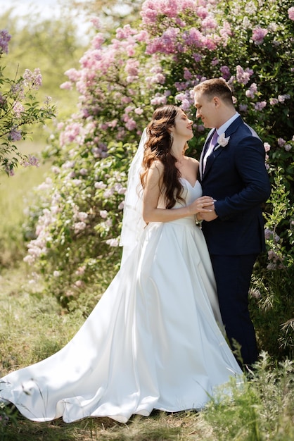 The groom and the bride are walking in the forest