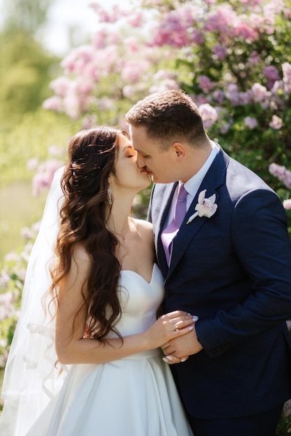 The groom and the bride are walking in the forest