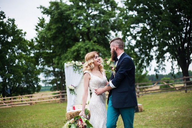 Groom and bride in motion in nature, rustic style