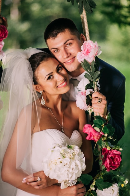 Groom and bride on swing