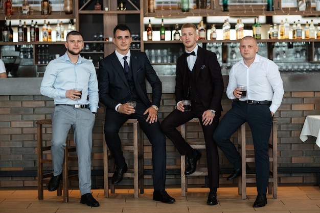 Groom in a brown suit and his friends