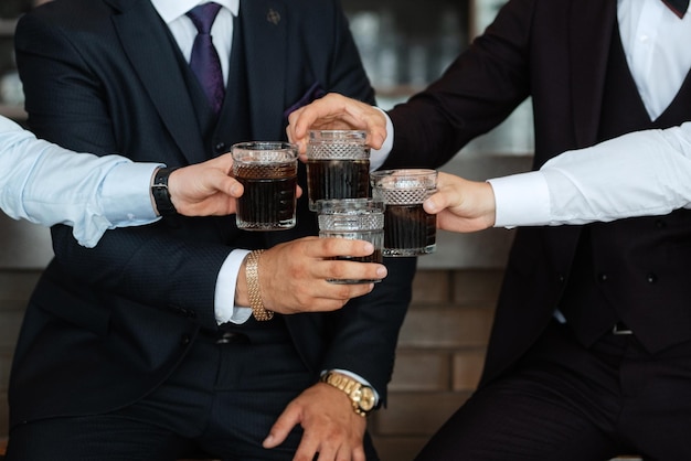 Groom in a brown suit and his friends