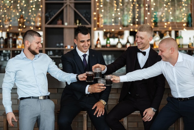 Groom in a brown suit and his friends