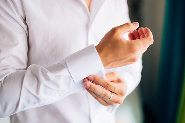 Groom buttoning cuffs