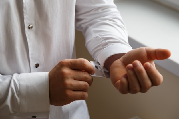 Groom buttons on a white shirt cufflinks