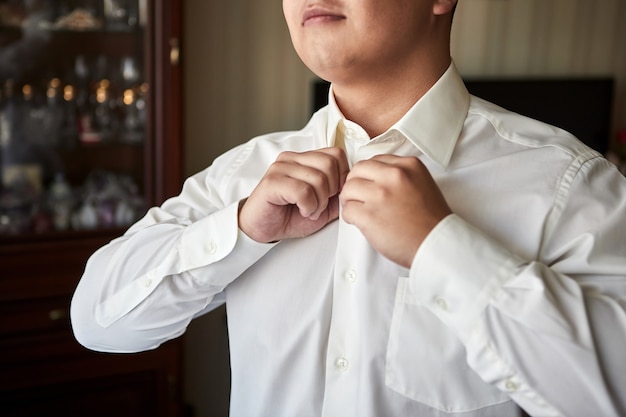 Groom getting ready in the morning before wedding ceremony