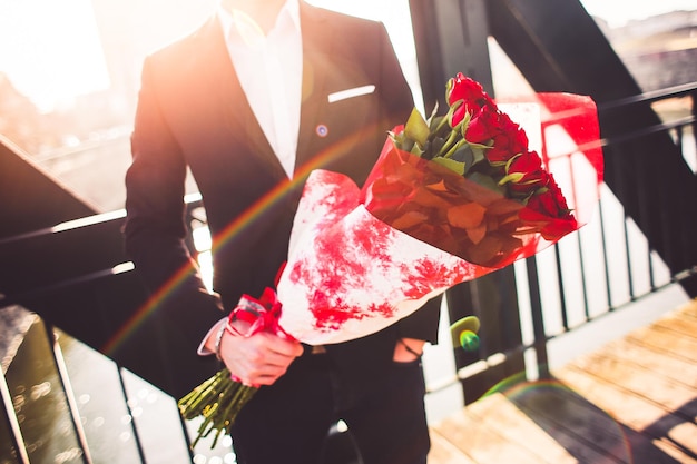 Groom holding wedding flower bouquet