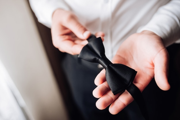 Groom holds a bow in his hands